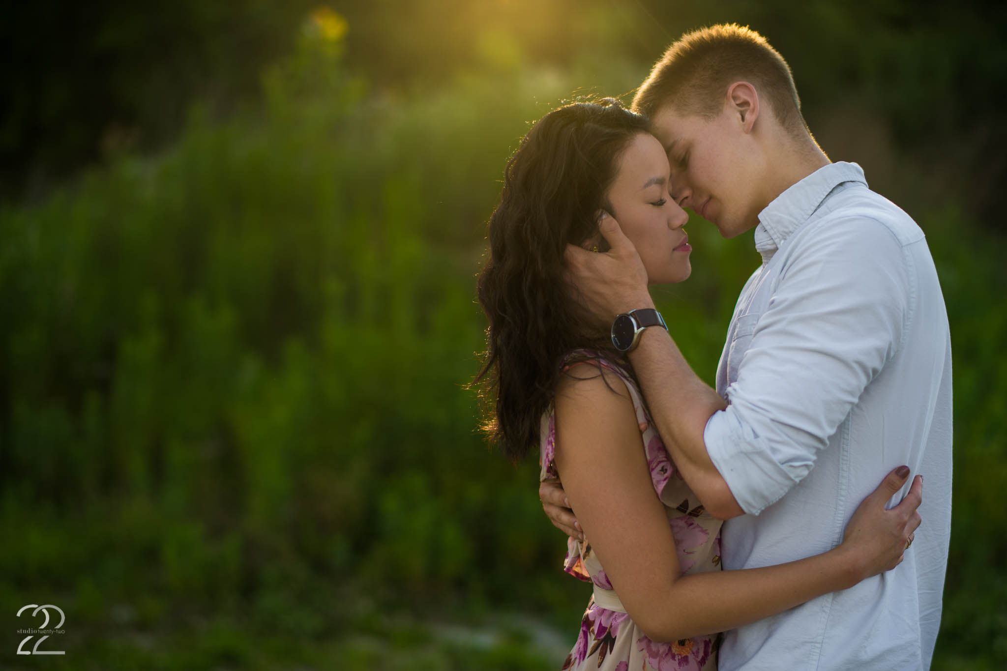 Man brings woman in for a kiss as the sun sets at Oakes Quarry Park by Dayton Wedding Photographer Studio 22 Photography